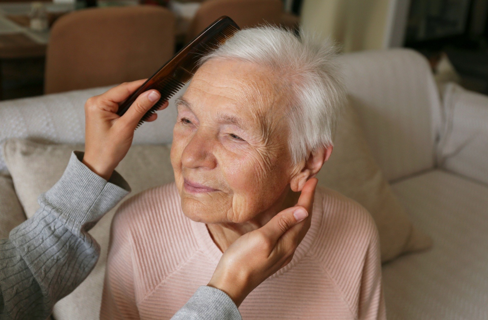 Older woman getting her hair combed