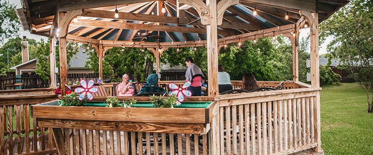 Outdoor gazebo with residents socializing