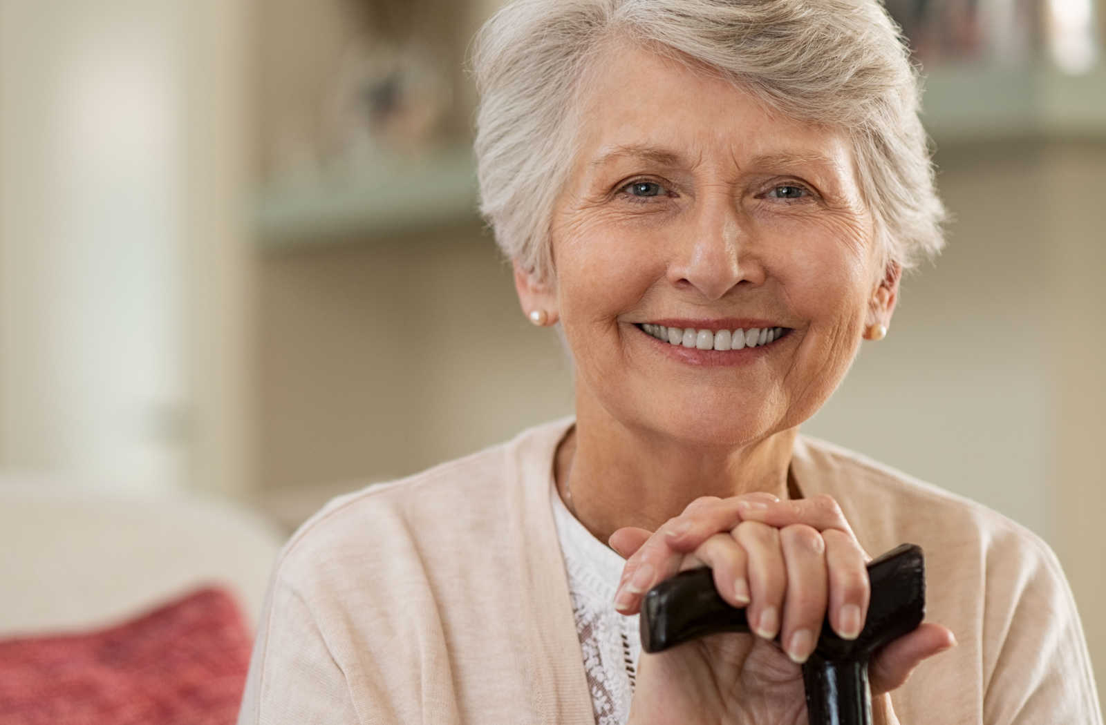 Senior woman smiling warmly with a cane
