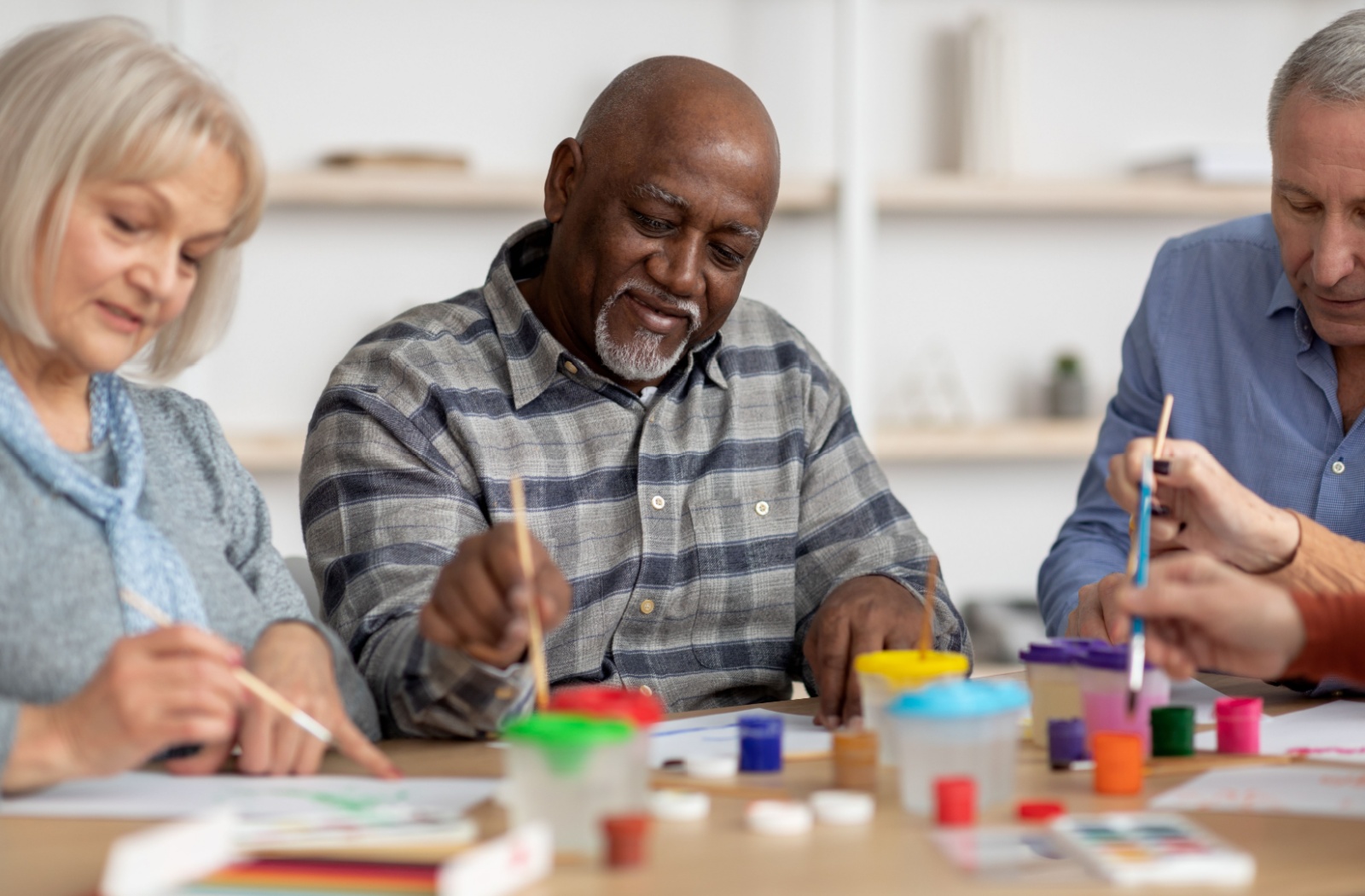 Residents engaged in a painting activity together.