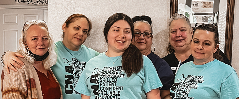 A group of staff members posing for a photo.