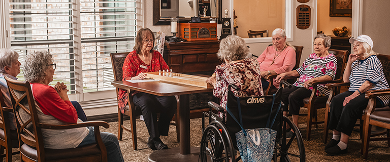 Residents engaged in a game together in a common area.
