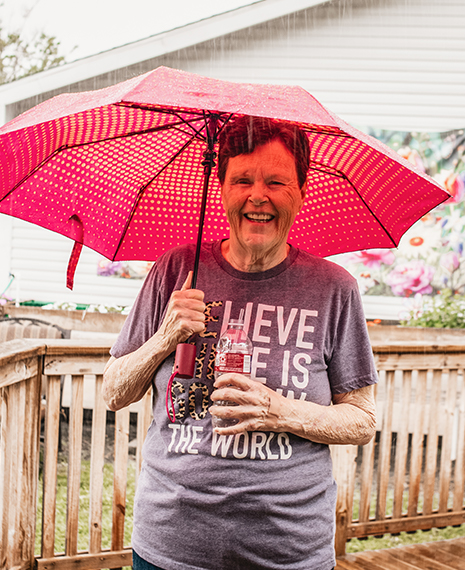 Resident enjoying the outdoors with an umbrella