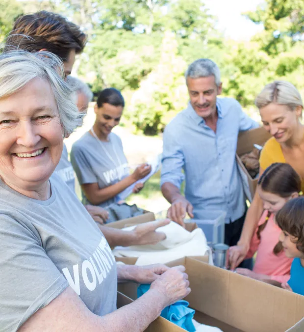 Residents and volunteers participating in an outdoor community activity.