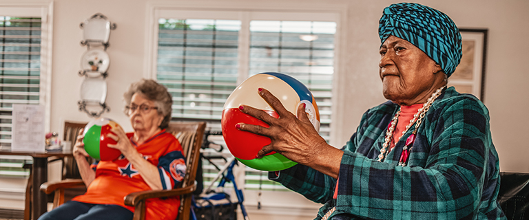 Residents engaged in an activity with beach balls.