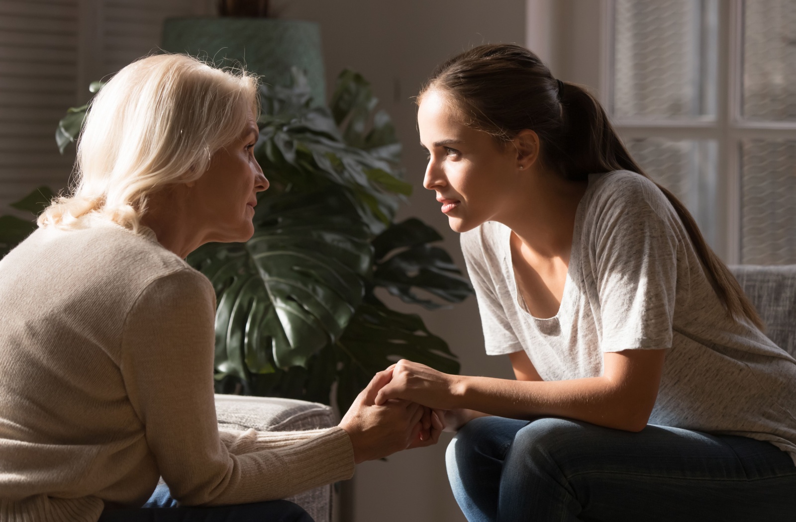 A caregiver holding hands with a resident.
