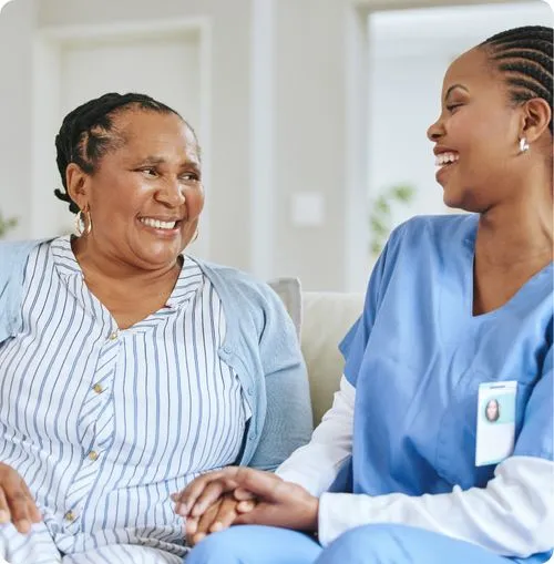 Caregiver and resident smiling together
