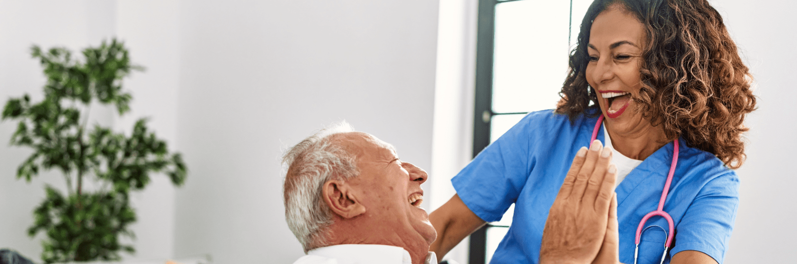 Staff member joyfully interacting with a resident
