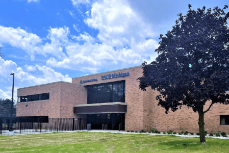 Exterior view of the facility building with landscaping.
