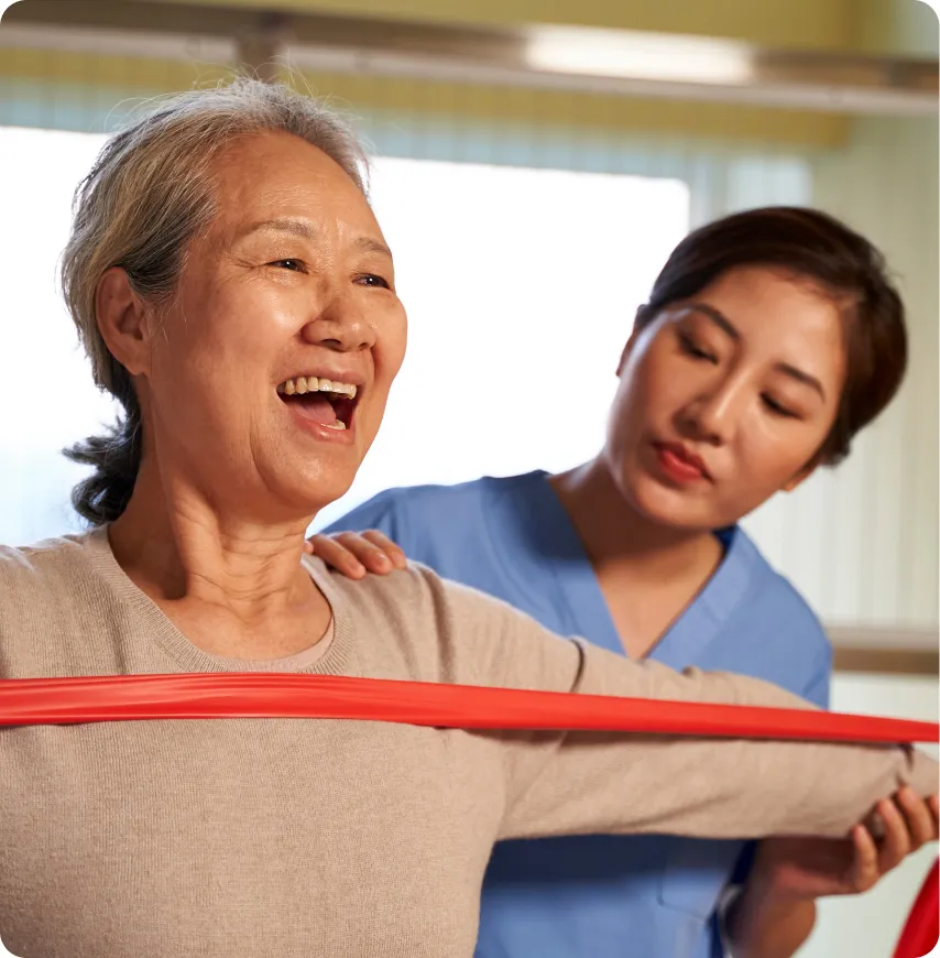 Senior resident exercising with staff assistance