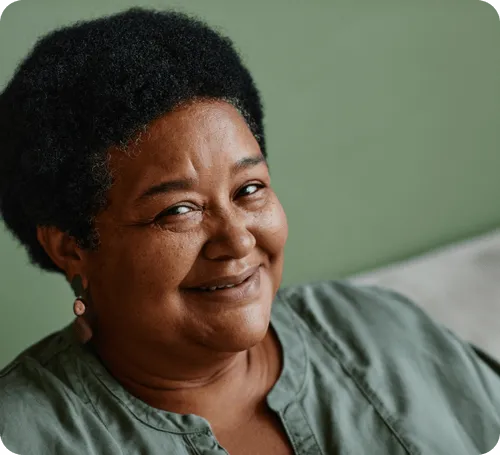 Portrait of a smiling older woman indoors.