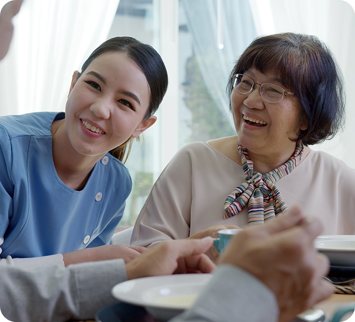 Staff member sharing a joyful moment with a resident