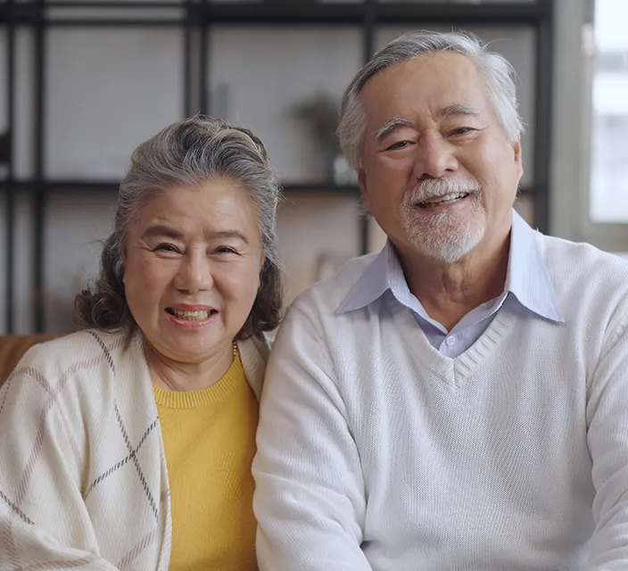 Smiling elderly couple in a cozy interior