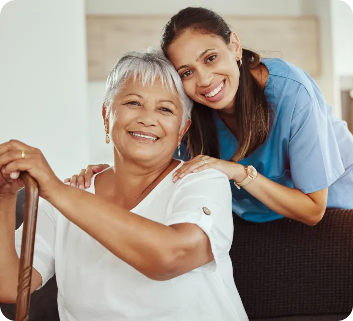 Resident and staff member smiling together