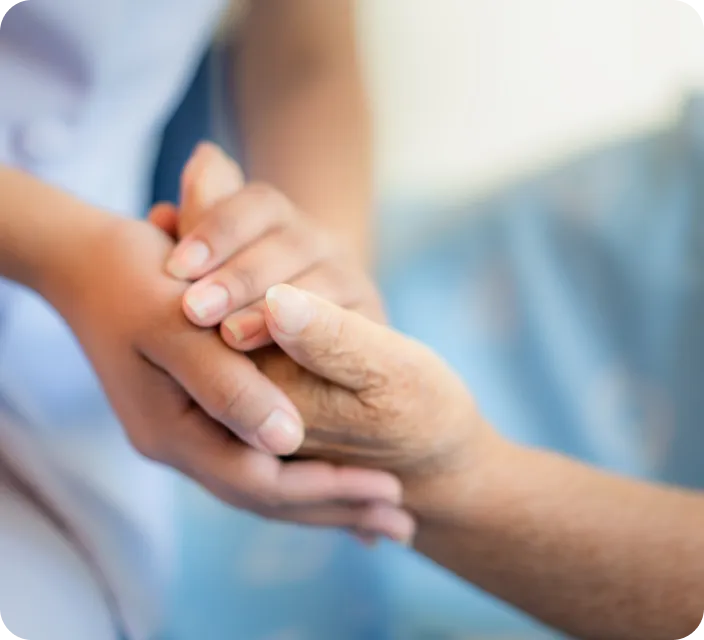 Nurse holding hands with elderly resident