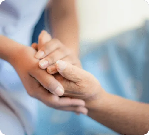 Caregiver holding a senior's hand