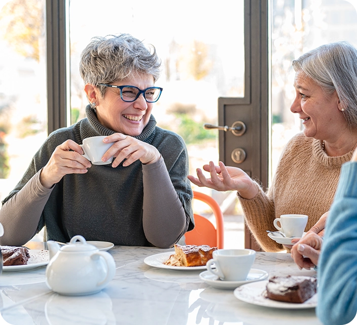 Residents enjoying coffee and conversation in a common area.