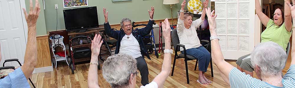 Residents participating in a seated exercise class