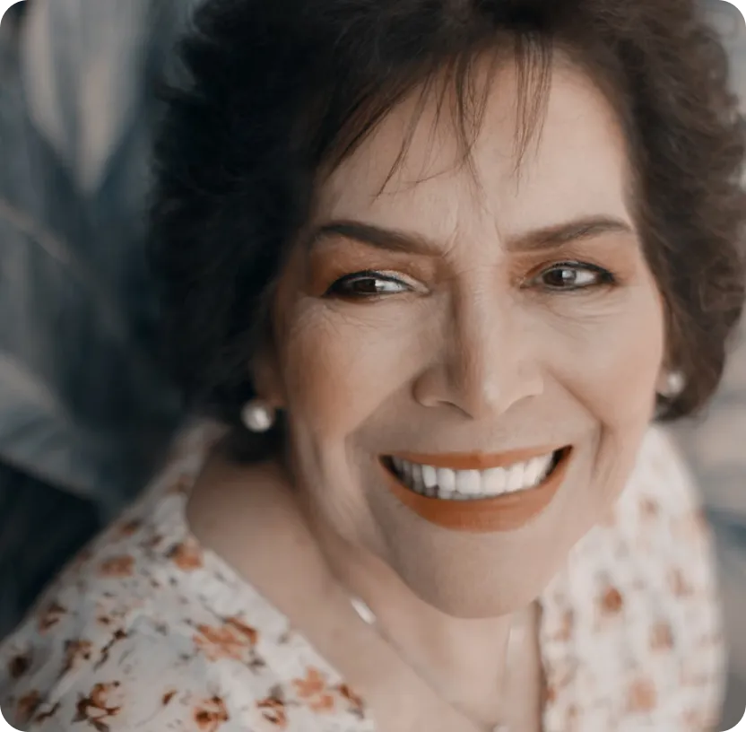 Smiling older woman with a floral shirt