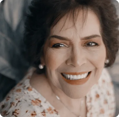 Smiling resident with a floral shirt