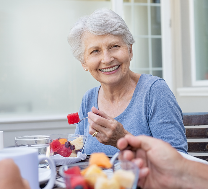 Senior woman enjoying a fruit snack outdoors