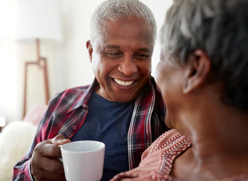 Two seniors sharing a joyful moment indoors.