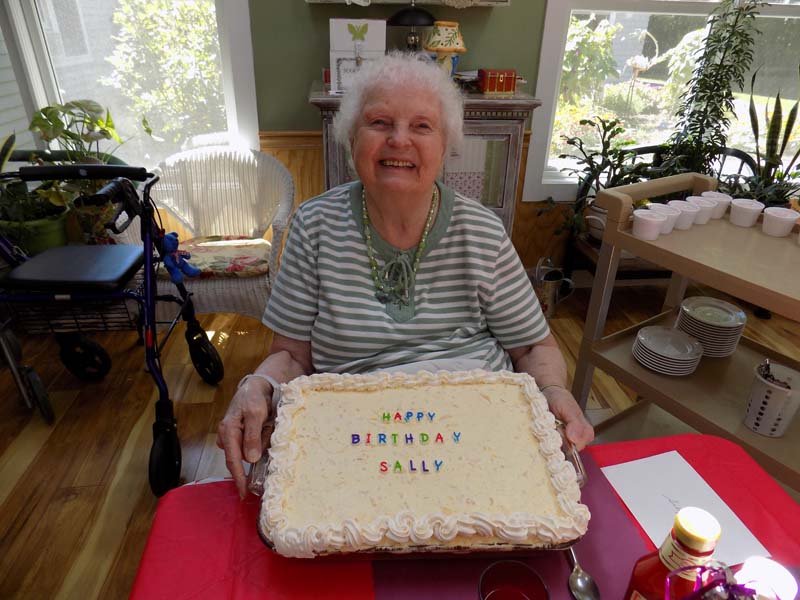 Senior woman celebrating with a birthday cake.