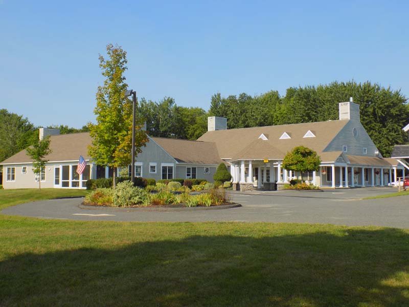 Exterior view of Sunset Home with landscaped areas.