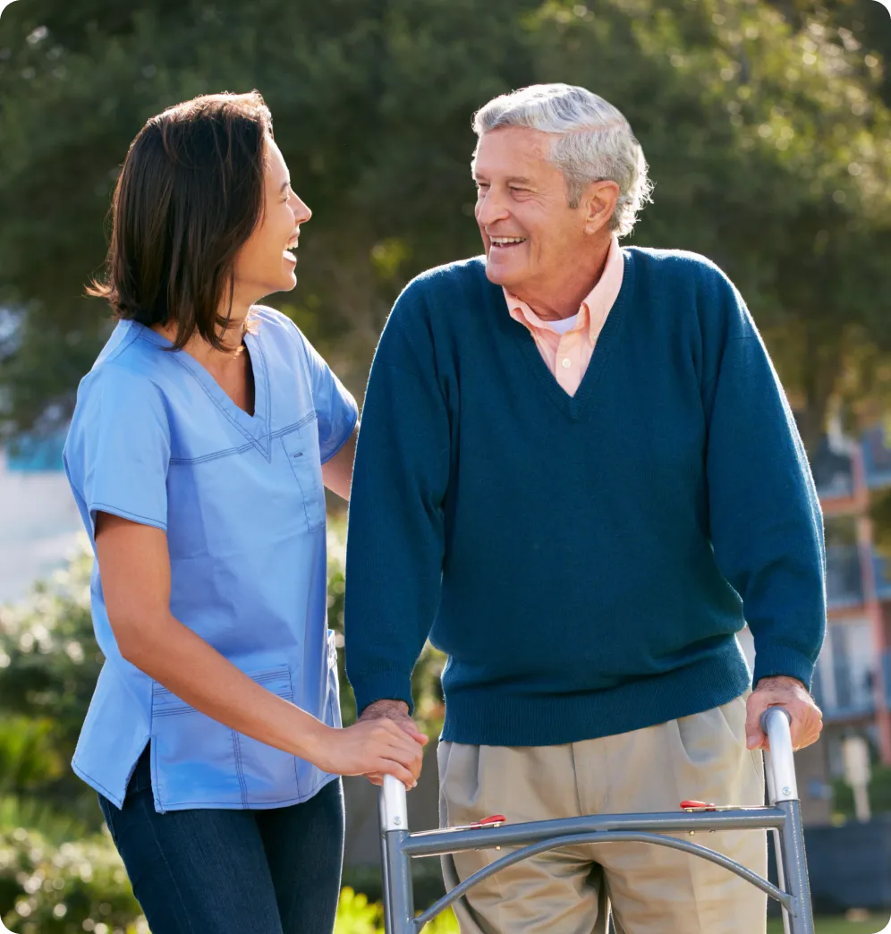 Staff assisting a resident outdoors