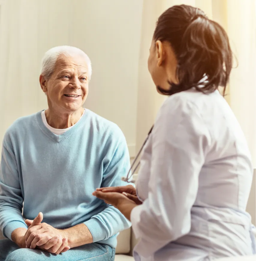 Resident engaged in conversation with a caregiver.