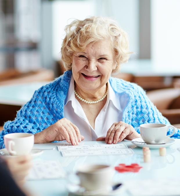 Senior woman smiling while playing bingo.