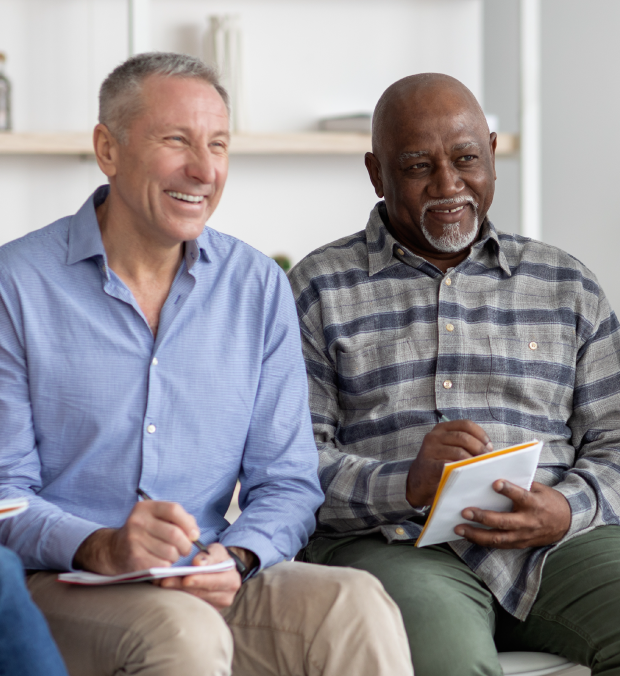 Two men engaged in conversation in a common area.