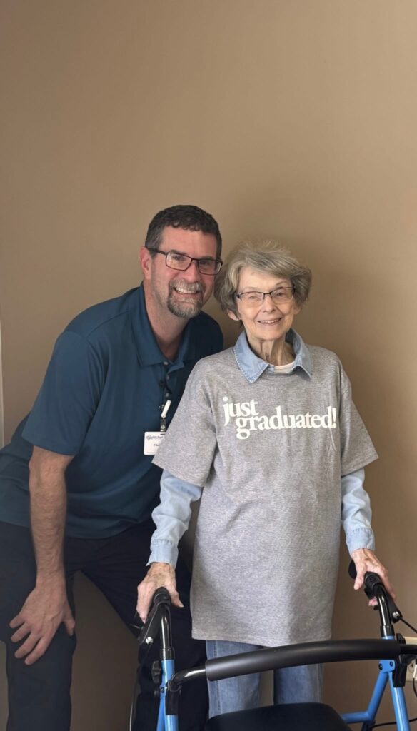 Staff member with resident celebrating graduation.