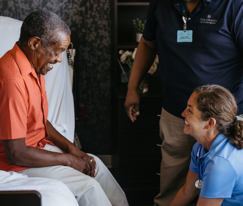 A caregiver interacting happily with a resident.