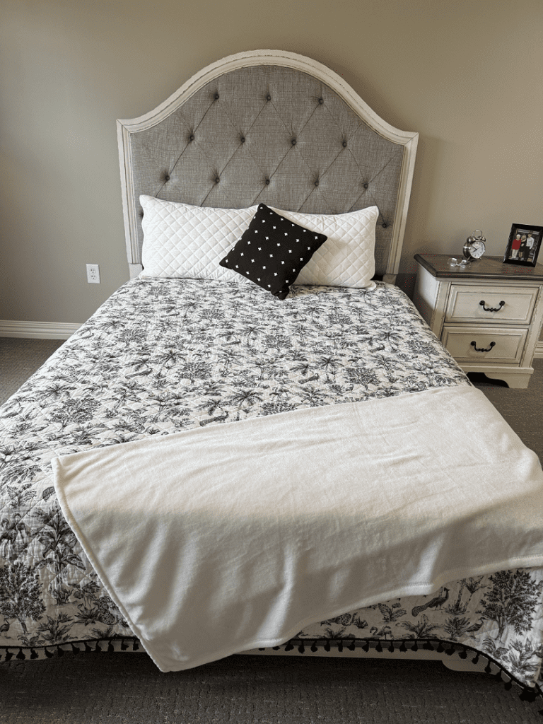 Cozy bedroom setup with elegant bedding.