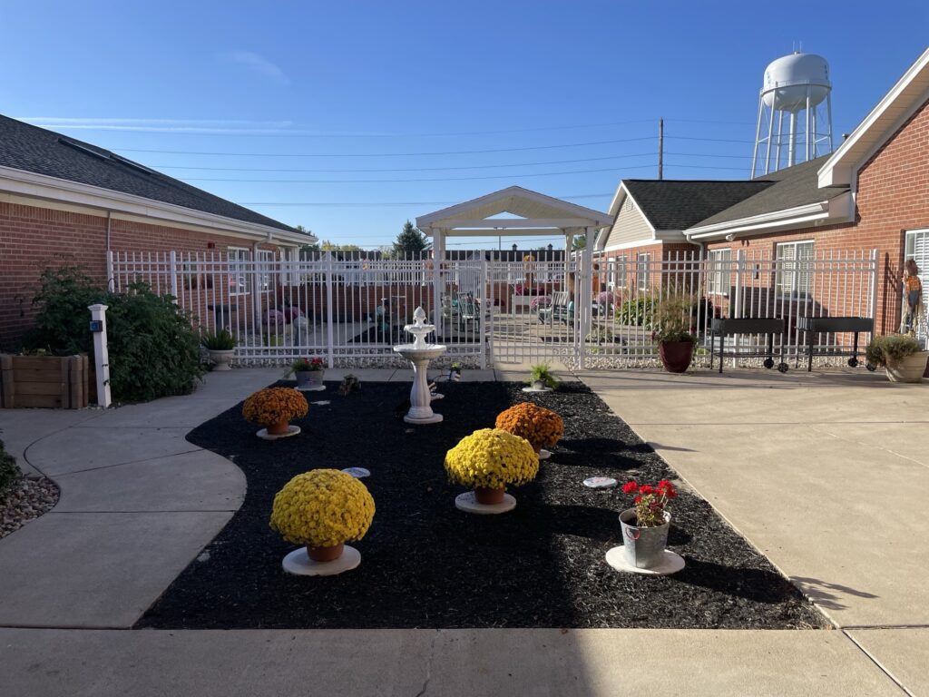 Outdoor garden area with flowers and fountain