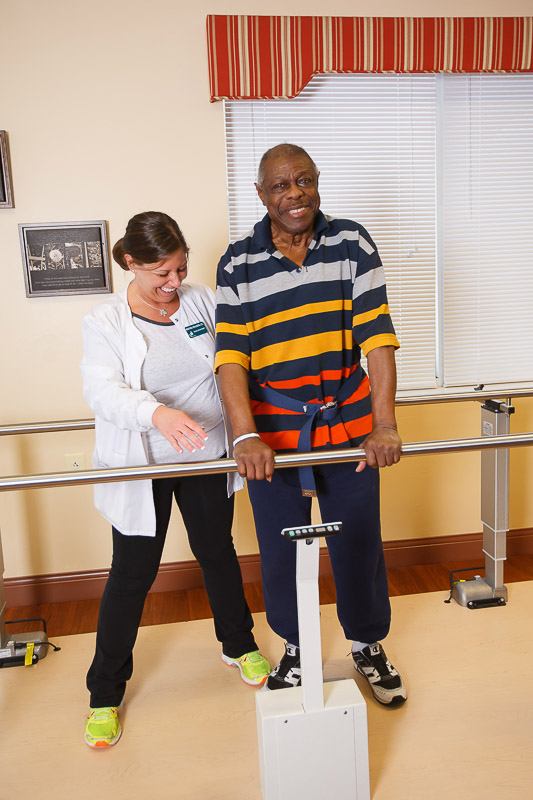 A staff member assisting a resident in therapy