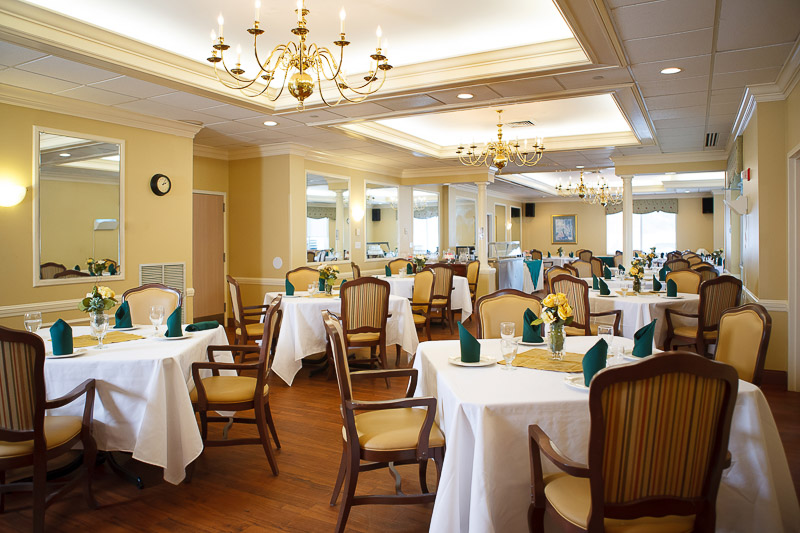 Elegant dining room with tables set for dining.