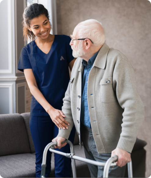 Nurse assisting an elderly man in a living room
