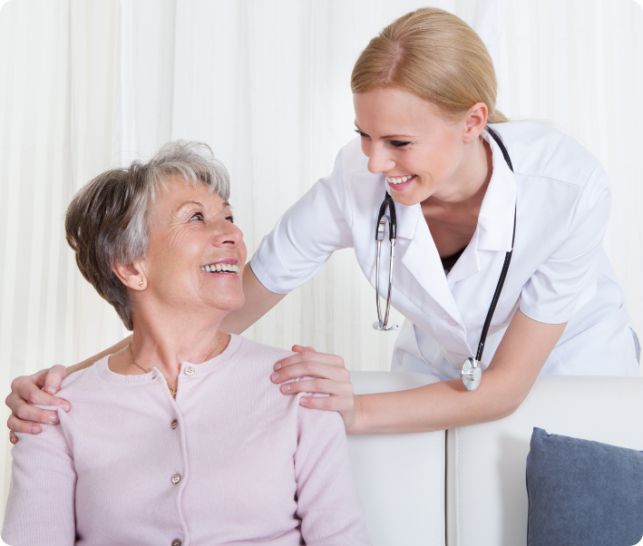 A smiling nurse interacting with a resident