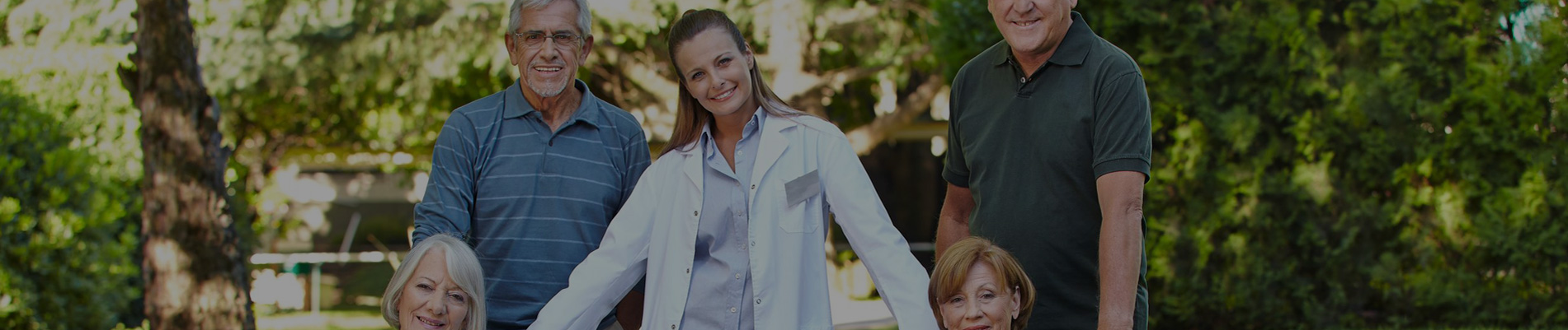 Group of residents and staff smiling outdoors