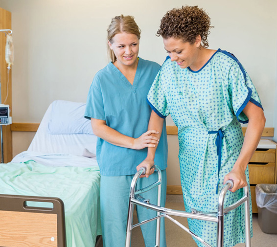 Staff assisting a resident with a walker