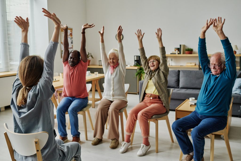 Residents participating in a seated exercise class