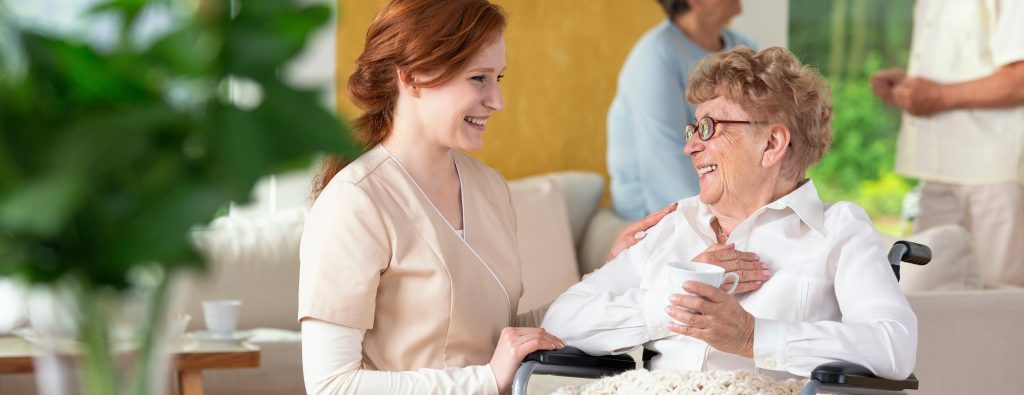 Caregiver interacting with a smiling resident