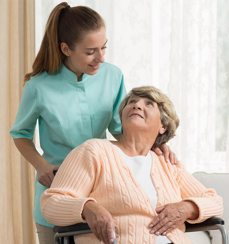 Staff interacting with a resident in a warm setting.