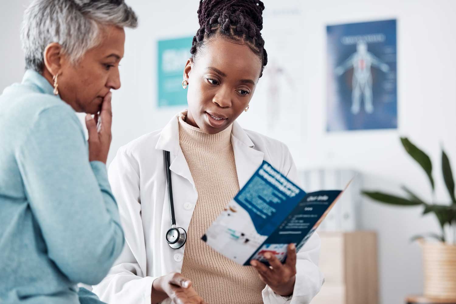 Healthcare professional discussing materials with a resident.