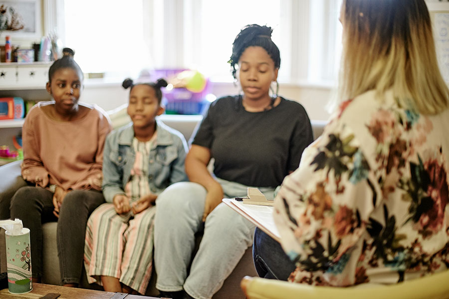 Three young residents engaged in conversation.