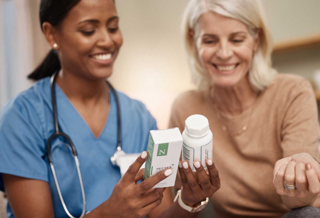 Healthcare professional assisting a senior resident with medications.