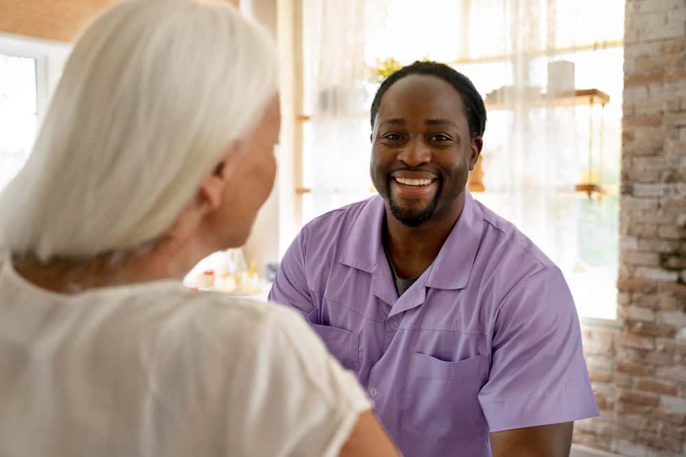 Caregiver interacting warmly with a senior resident