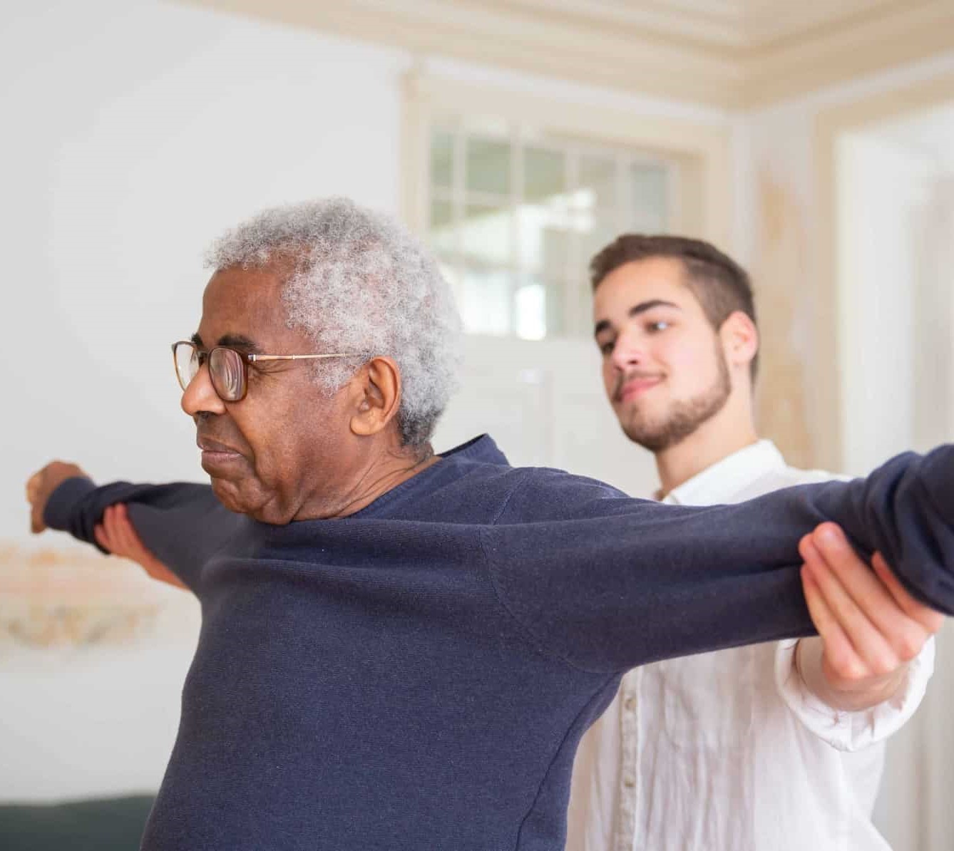 Caregiver assisting resident with a sweater